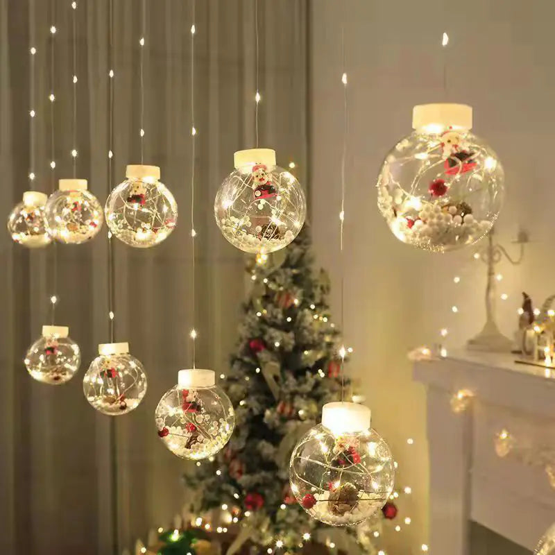 LED Holiday Curtain String Lights featuring hanging globe ornaments with festive fillers, perfect for indoor Christmas decor near trees and mantels.