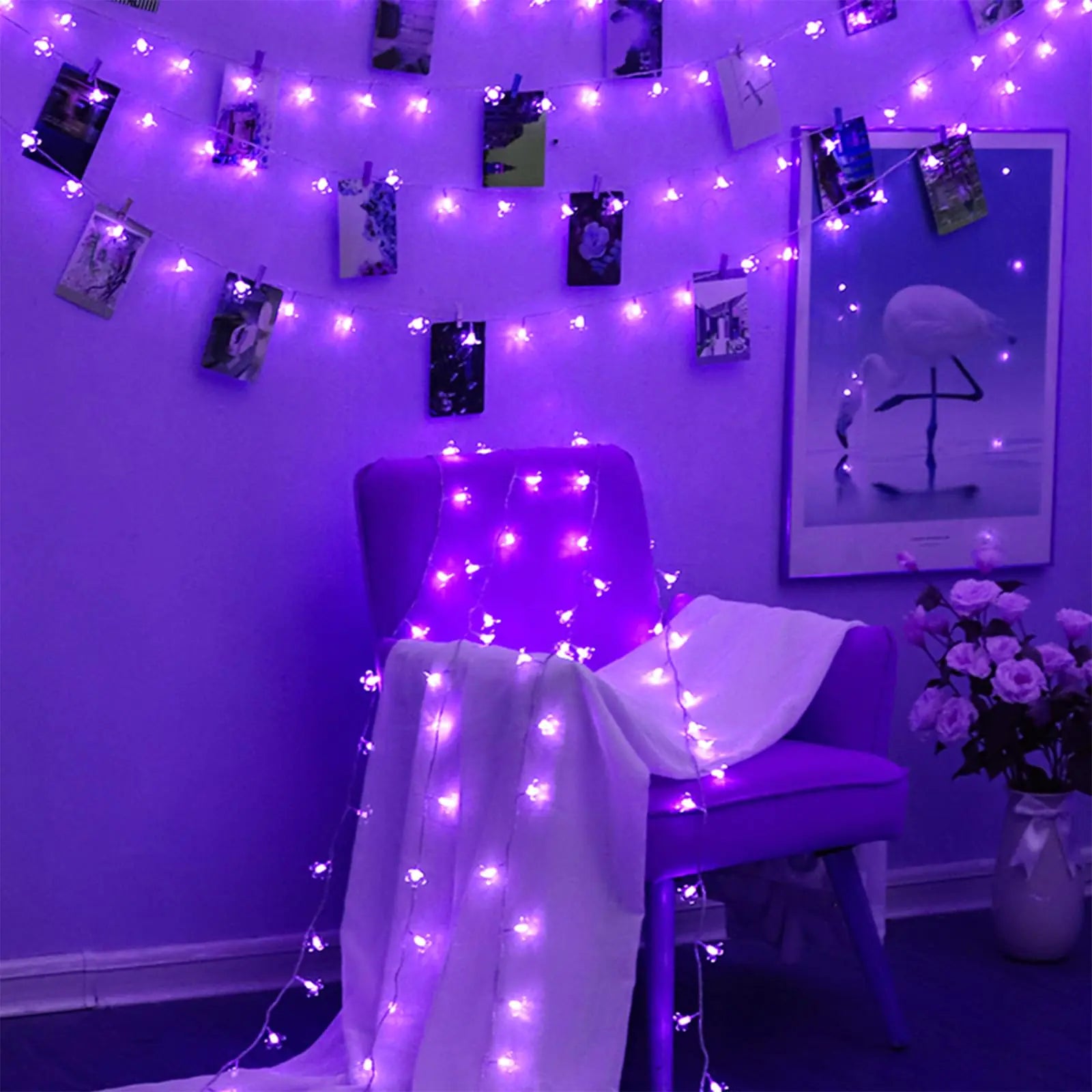 LumiBloom 33ft LED Cherry Blossom String Lights in purple draped over a chair and wall, creating a cozy indoor decorative lighting setup.